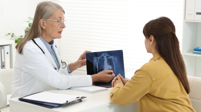 Doctor showing lung x-ray results to woman