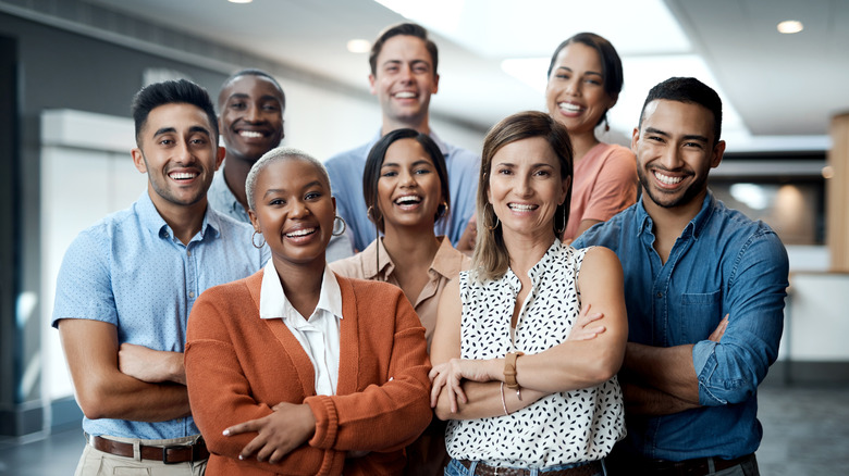 A group of people standing together and smiling