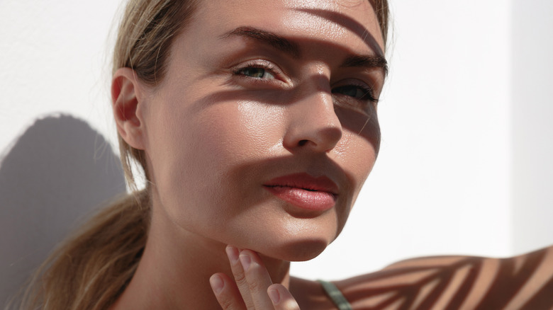 A woman with her face obscured by shadows