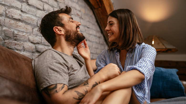 happy young couple cuddling in the living room