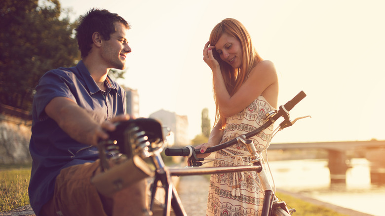 Beautiful love couple enjoying a romantic summer day by the river.