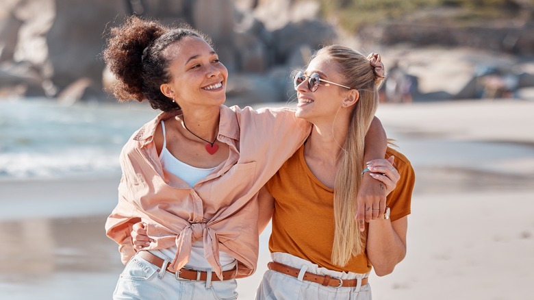 Lesbian couple walking on beach