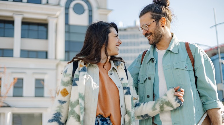 Happy couple walking together on a city street