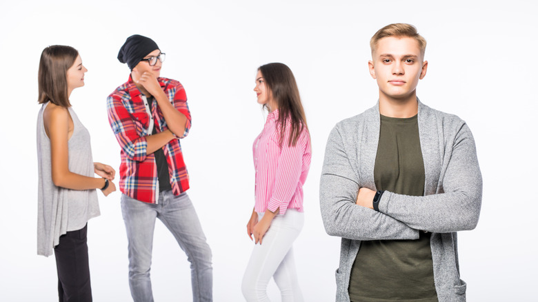 A man looking dissatisfied with a woman's friend group