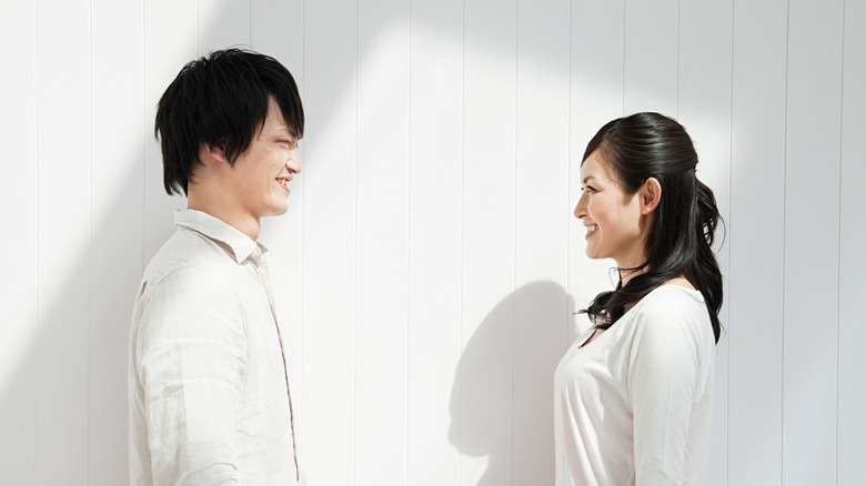 A man and a woman are looking at each other