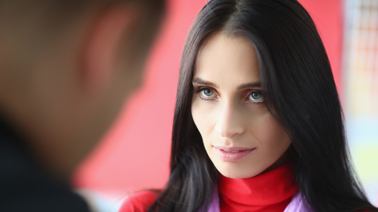 A woman looking at a man's face