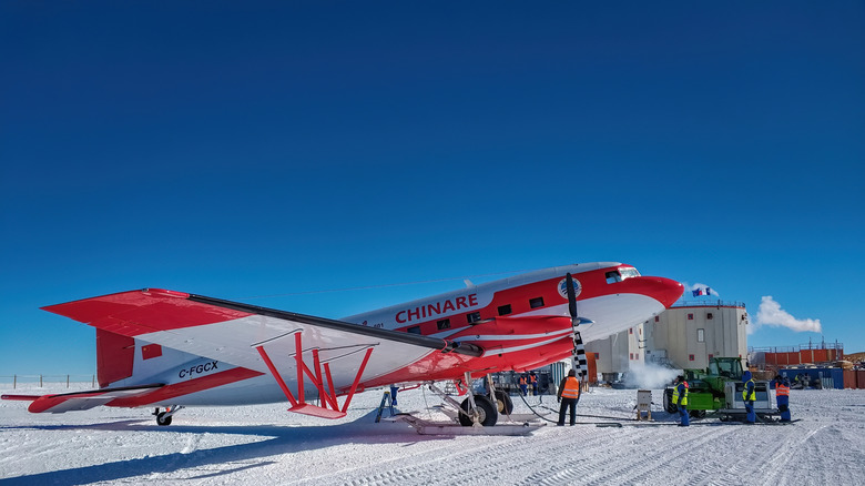 Red and white plane parked on ice at Dome C in Antarctica
