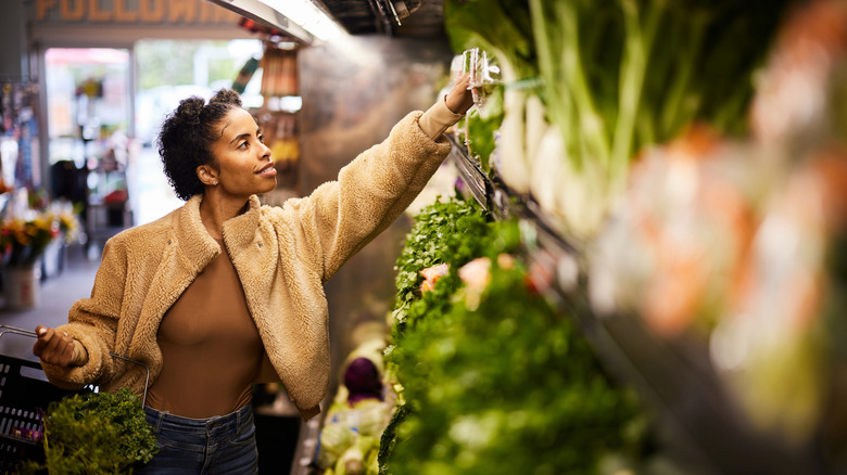 Woman browsing the vegetable aisle in the store