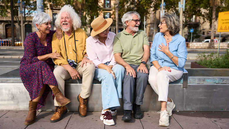 Group of happy seniors smiling and chatting