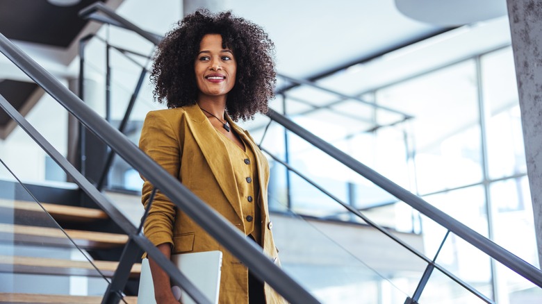 Woman walking down stairs with a confident expression