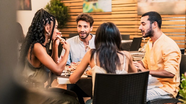 Group of friends chatting while out for dinner