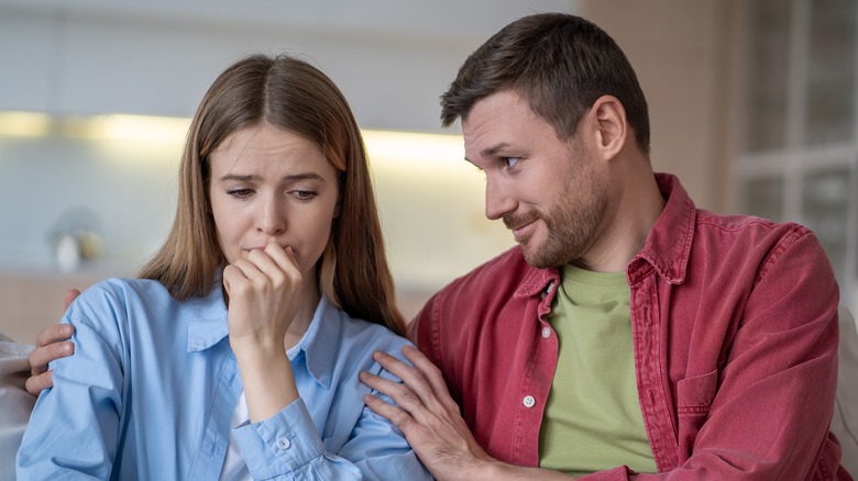Upset woman being comforted by her partner