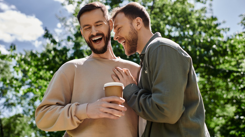 A happy couple sharing coffee and laughing