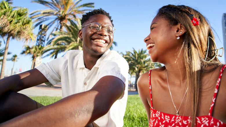 A couple talking and smiling outdoors