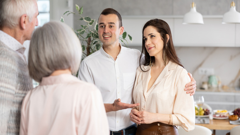 A couple meeting with parents in a home kitchen