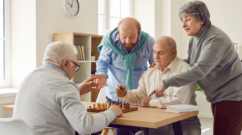 Group of older people playing a game of chess