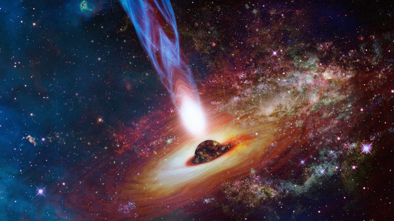 A quasar in deep space is seen surrounded by stars and space dust