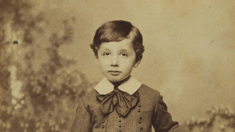Albert Einstein posing for a photograph at five years old.