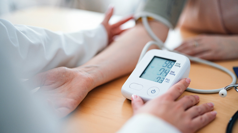 doctor checking the blood pressure of a patient