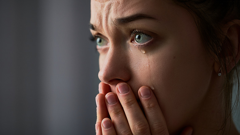 A person crying with tears down her face