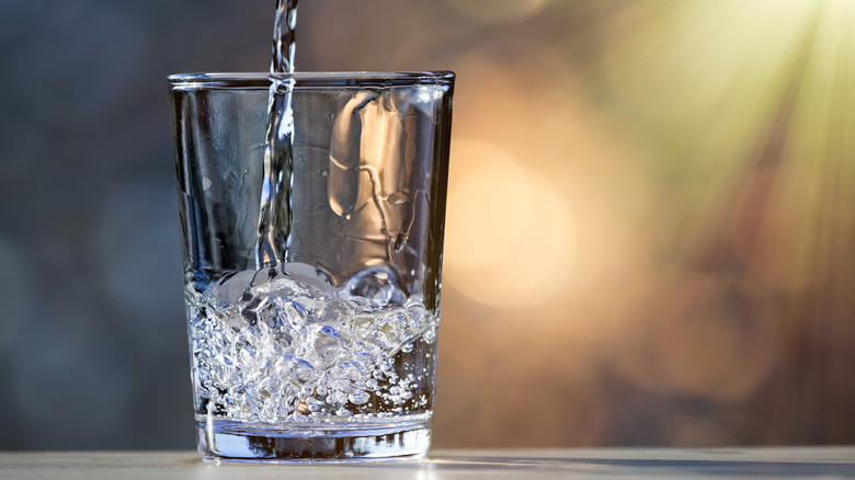 pouring water into glass
