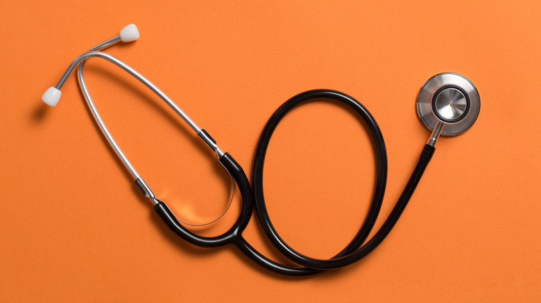 A stethoscope on an orange background.