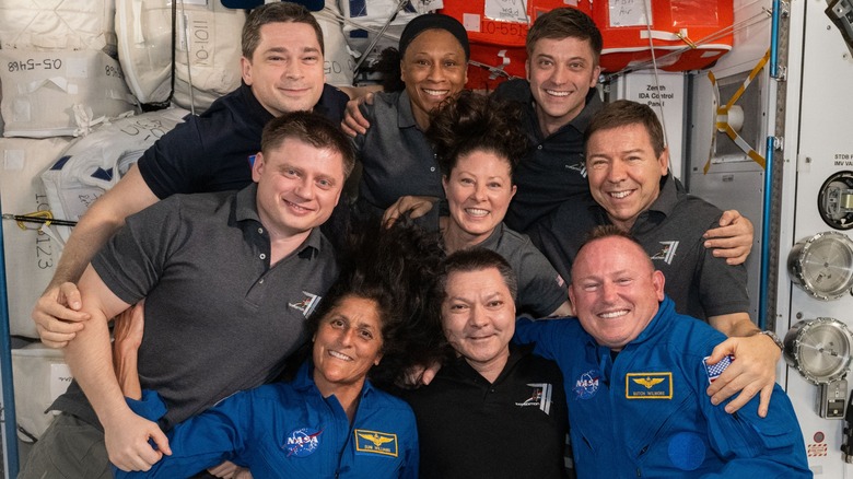 ISS Expedition 71 members pose for a team portrait