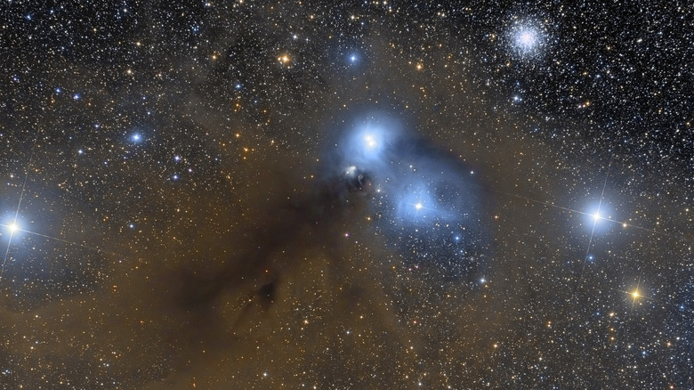 Corona Australis in starry sky with dust cloud