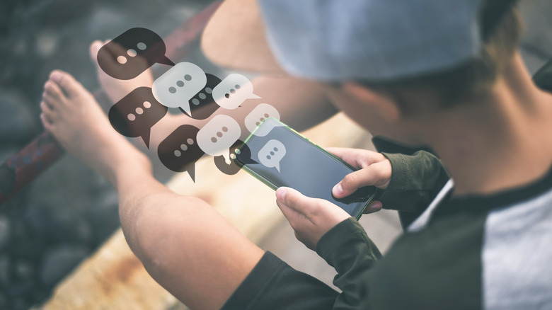 A boy is using a smartphone