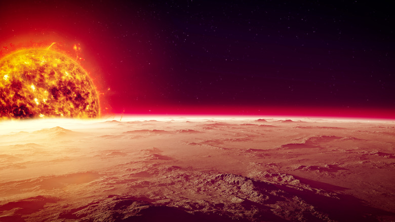 The sun is seen in space with the surface of Mercury in the foreground