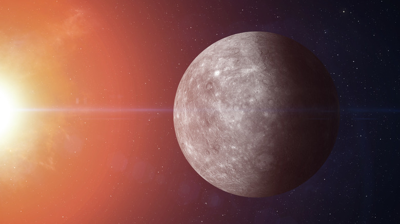 Mercury is seen in space with the Sun's light extending into the frame from the left
