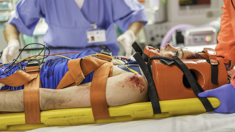 Paramedic and nurse admitting a critical patient into emergency room