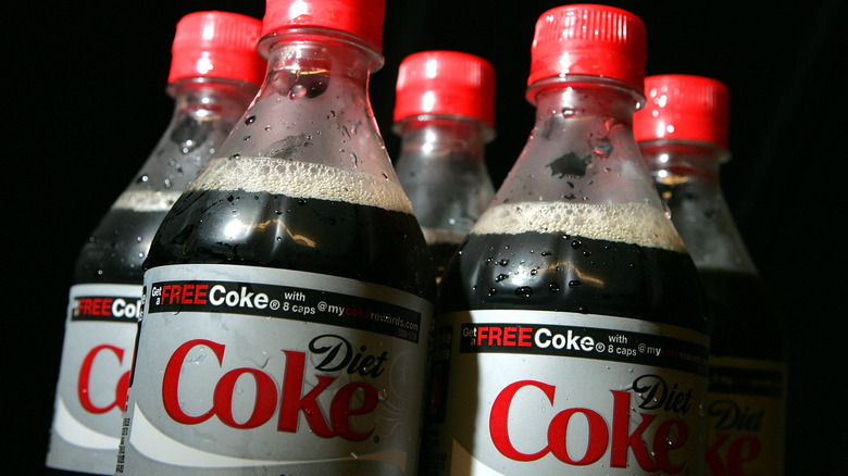 Bottles of Diet Coke on an ominous black background
