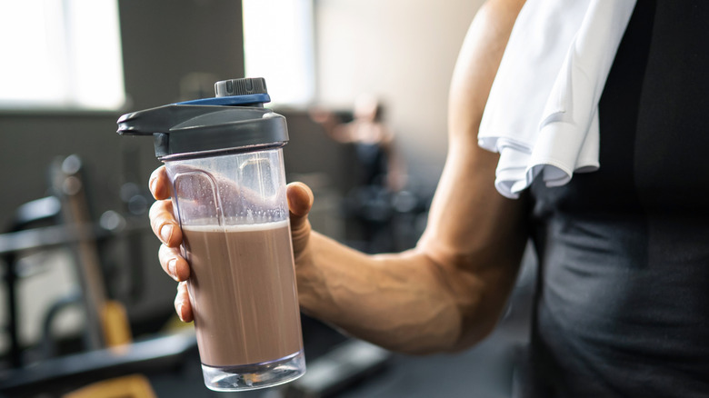 Hand holding a bottle of mixed protein shake
