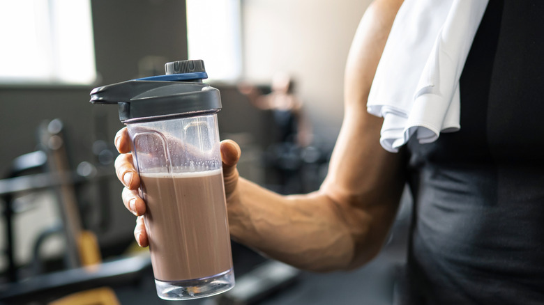 Hand holding a bottle of mixed protein shake
