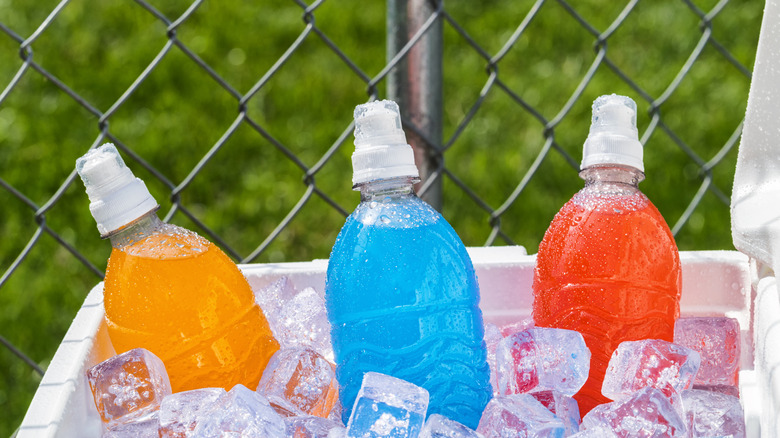 Three different sports drinks in a box of ice