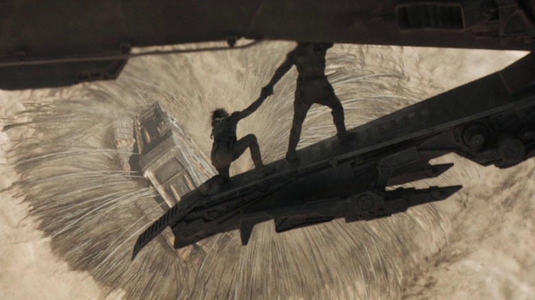 Characters looking down at sandworm mouth as it swallows harvester
