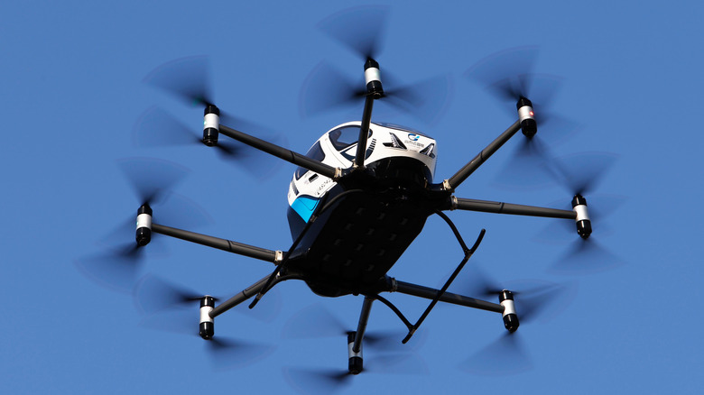 EHang's EH216-S unmanned eVTOL (electric vertical takeoff and landing) aircraft is seen airborne from below against a blue sky