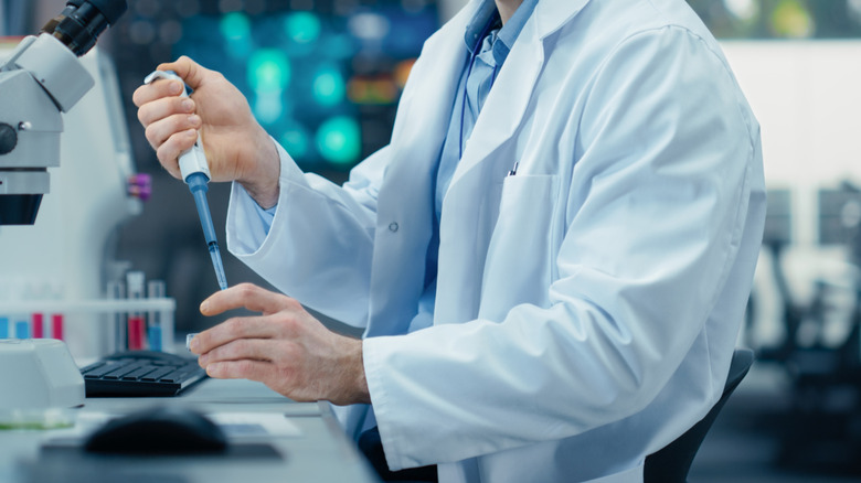 Close-up of a scientist working in a white lab coat