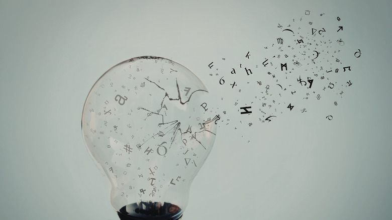 Mathematical symbols appear to flow out of a shattered lightbulb.