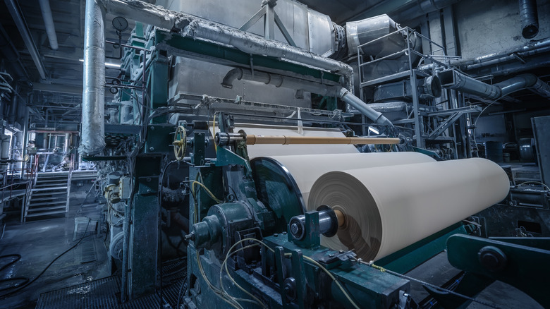 paper mill rolling out sheets of paper