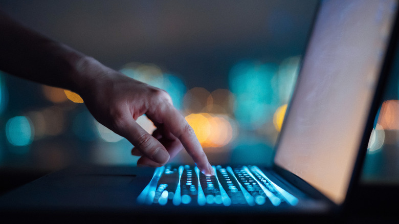 person using laptop computer to analyze data