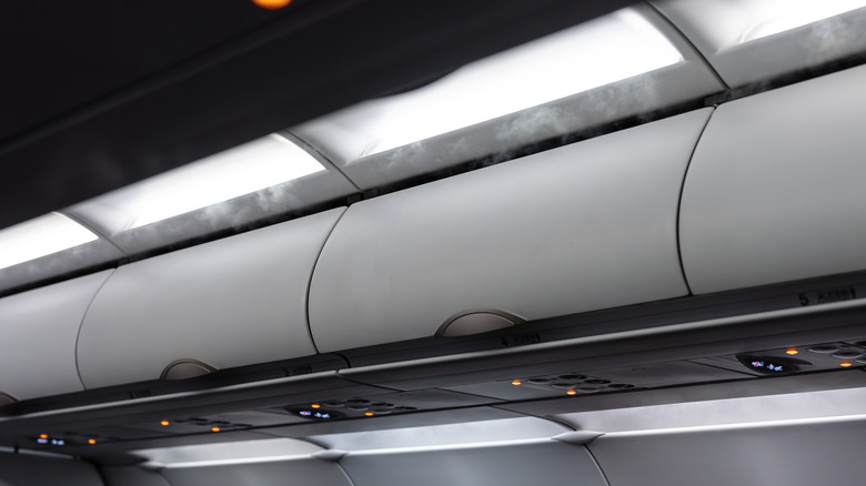 Steam is seen coming through the ventilation of an airplane cabin