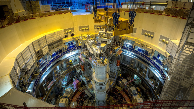 ITER tokamak viewed from above with metal scaffolding in pit