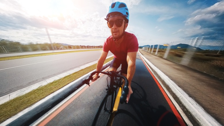 Man cycling quickly on road