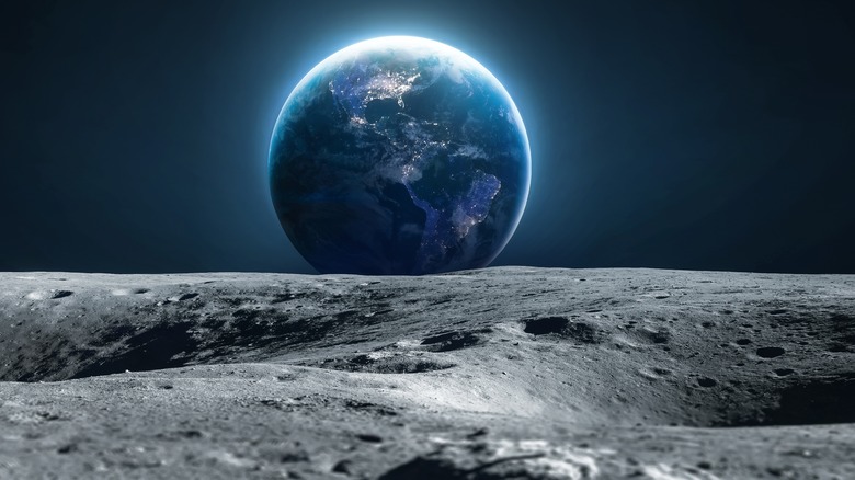 Surface of moon with Earth in background