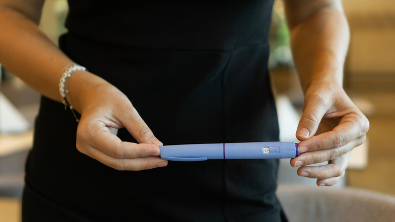 Woman's hands holding an Ozempic pen
