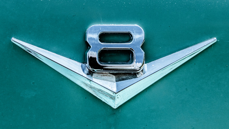 V8 logo on green car