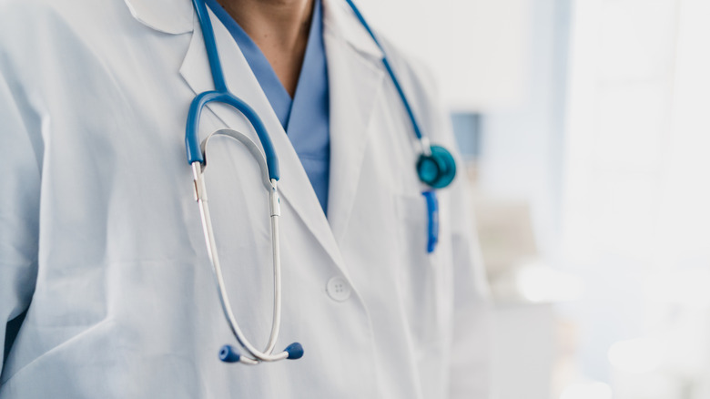 A doctor's chest with a stethoscope is seen in closeup