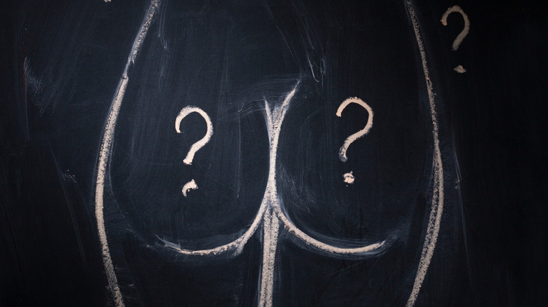 Chalkboard drawing of buttocks with a question mark on each cheek